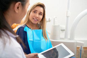Pretty young woman visiting dentist