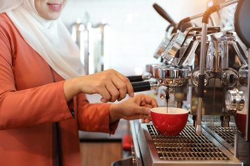 young muslim barista girl hands making coffee