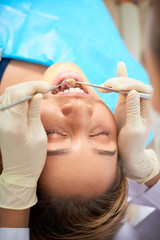 Doctor checking teeth of patient
