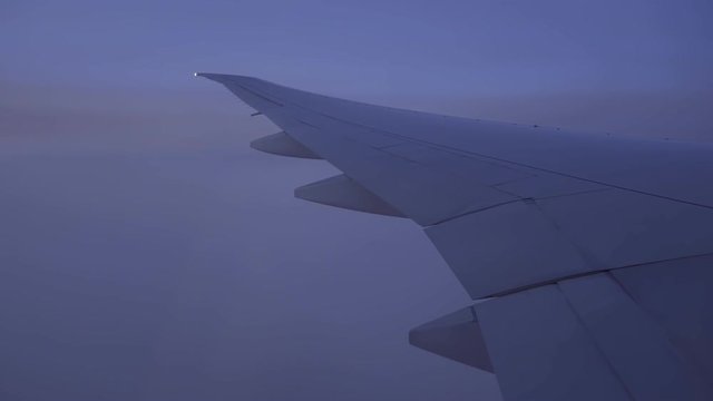 plane wing flying in the sky, view of evening sky outside window plane