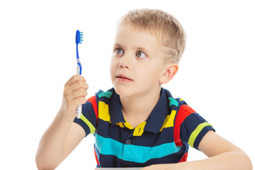 Smiling boy with a toothbrush in his hand. Close-up. Isolated on a white background.