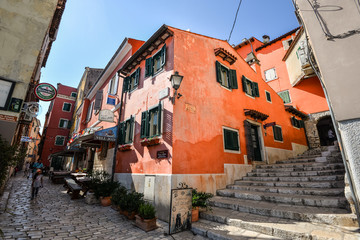 Fototapeta na wymiar View on bright building exteriors of Coastal town of Rovinj, Istria, Croatia. Rovinj - beautiful antique city. Cororful building facades in old town of Rovinj