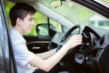 Teenager learns to drive a car