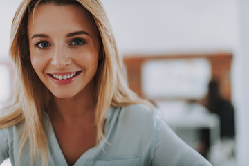 Close up of the young blonde woman smiling
