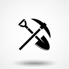 Shovel and pickaxe icon. Black icon isolated on white background. Shovel and pick axe silhouette. Simple icon. Web site page and mobile app design vector element.