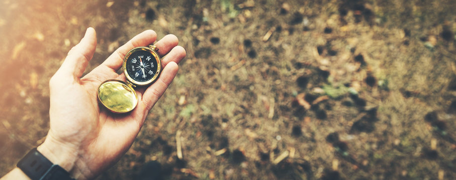 direction search exploration concept - compass in hand - Powered by Adobe