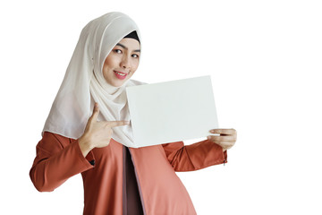 young muslim businesswoman showing blank white paper and pointing it (you can put letter on it)