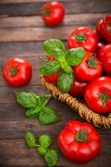 Fresh ripe tomatoes and basil in the basket