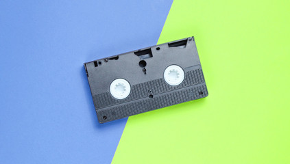 Outdated videotape on a two-ton paper background, Top view. Minimalism