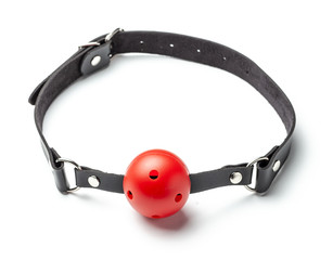 Red Ball gag in mouth isolated on white background. Intimate toys. Sex abuse slavery