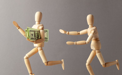 Stealing money. The thief with money runs away from the person