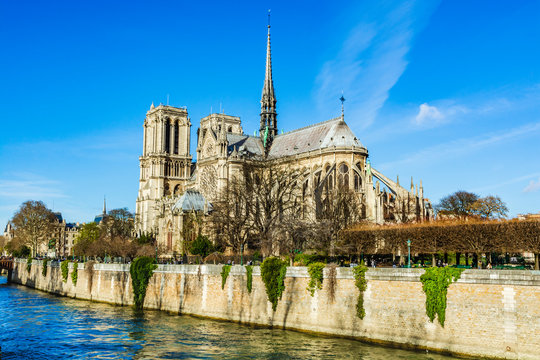 Side view of Notre Dame Cathedral and 19th-century spire by Eugene Viollet le Duc destroyed in the April 2019 fire, seen from the backs of river Seine in Paris, France