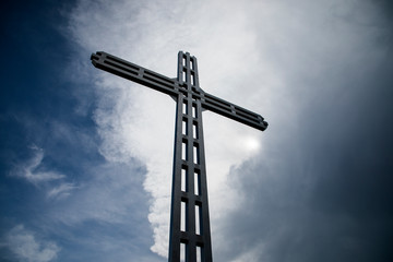 A Christian cross, a background of clouds and sunshine