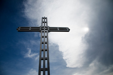 A Christian cross, a background of clouds and sunshine