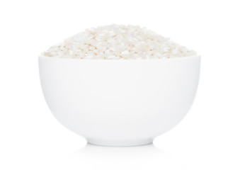 White bowl of raw organic arborio risotto rice on white background. Healthy food.