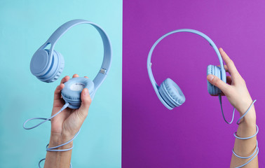Two Hand wrapped cable holds headphones on blue purple background