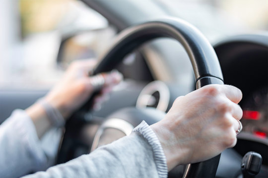 Close up of hands on steering wheel shallow dof