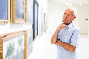 Naklejka na ściany i meble Man observing painting gallery