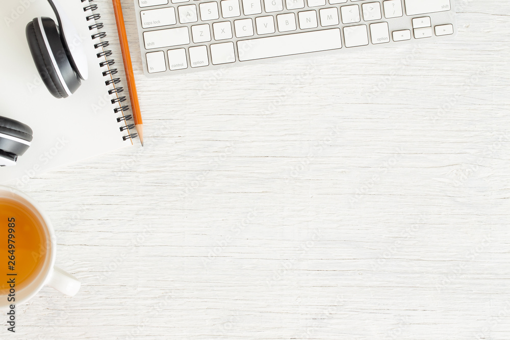 Wall mural flat lay photo of office desk with earphone and keyboard,copy space on white background with noteboo