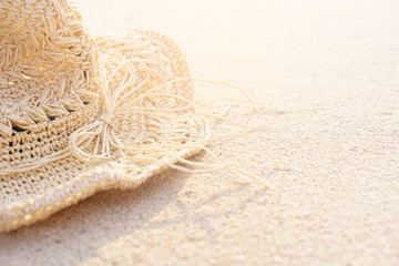 Background of Sand beach with accessories straw hat in summer time. Can add text to the left.