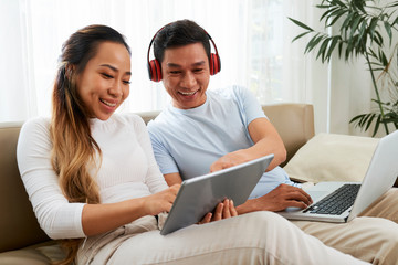 Fototapeta premium Asian couple watching new show episode