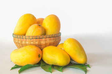mangos in a basker on a white background