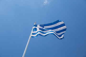 greek flag waving on blue sky clouds greece