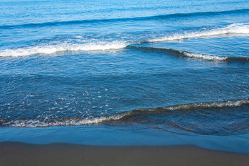 Fantastic soft wave layers on sand at the sea.