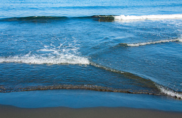 Fantastic soft wave layers on sand at the sea.