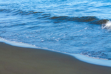 Fantastic soft wave layers on sand at the sea.