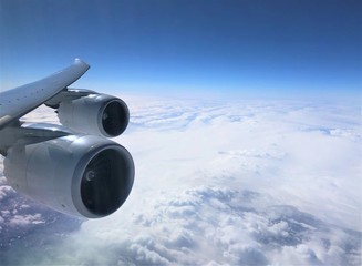 Blue sky with white clouds as looking through airplane window on the flight from Atlanta USA to South Korea .