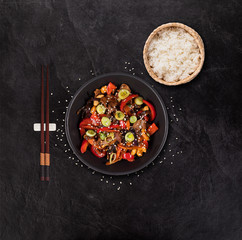 Szechuan beef asian food background with various ingredients on stone table.