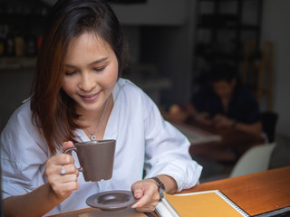young Asia woman sitting enjoy in coffee cafe