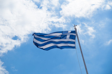 greek flag waving on blue sky clouds greece