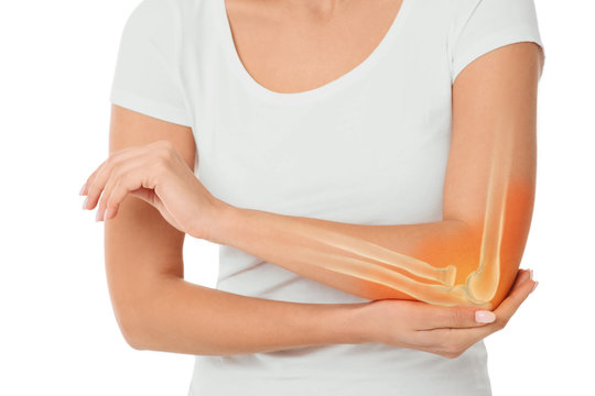 woman suffering pain in the elbow. Composite of image arm bones and elbow