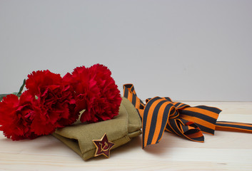 Victory day composition with clove, flight cap and saint George ribbon with free space