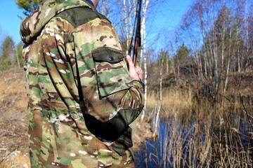 A novice hunter with a firearm on a spring hunting game.