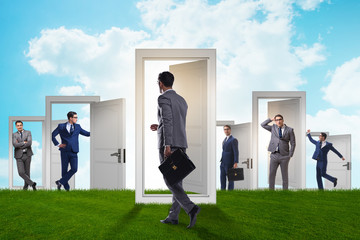 Fototapeta premium Businessman in uncertainty concept with many doors