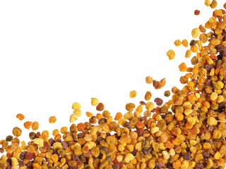 Extreme closeup view of bee pollen on white background. Isolated one edge. Copy space. Top view or flat lay.