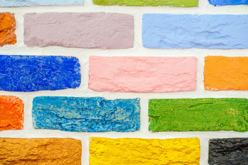 Brick wall. Colored bricks. Wall painted with different colors of paint. Coloring the walls....