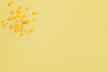 Pills on a yellow background. Design concept. Pills from a sunshine. Sunstroke. Summer diseases background. Copy space