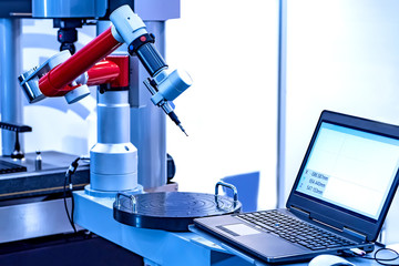 Measuring machine with a manipulator arm. Three-dimensional coordinate measurement. Check sizes. 3D check of the sizes of parts. CMM after machining process in industrial factory
