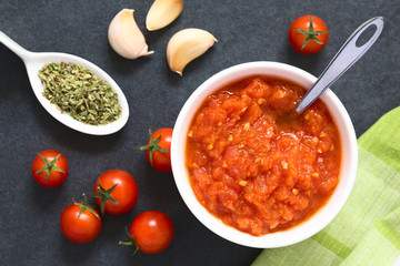 Homemade traditional Italian marinara or pomodoro tomato sauce made of fresh tomato, garlic, dried oregano and salt, photographed overhead with natural light (Selective Focus on the top of the sauce)