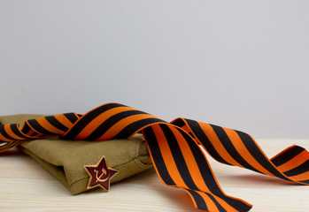 Victoru day composition with soviet flight cap and Saint George ribbon