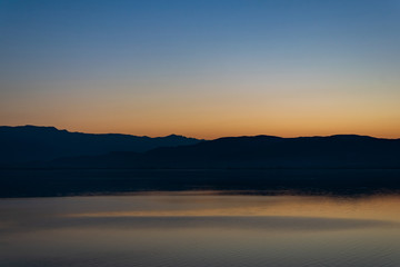 View of the lake and mountains on a sunny spring day.