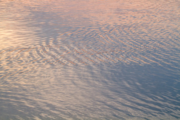 Water abstract background. Abstract colorful water color, pink and blue tone. Sunlight is reflected in the water . For add text .Abstract background photo. Closeup.