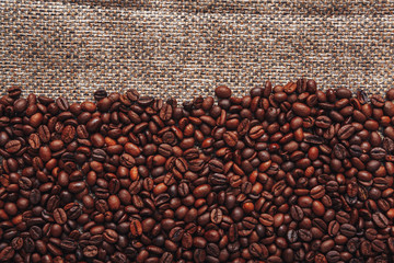 Coffee beans and sackcloth background., place for text