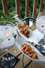 fancy drinks and snacks on a glass table