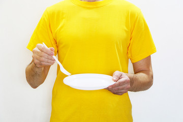 Health - a man  eats from plastic dishes and hurts his health