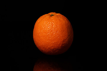 Oranges fruit on a black background with reflection